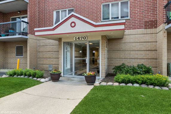 Front view of a building entrance with a brick facade.