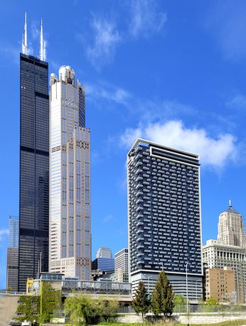 Elevated view of tall skyscrapers against a clear blue sky.
