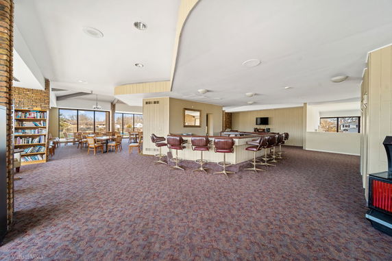 Indoor view of a club house with a bar and seating area.