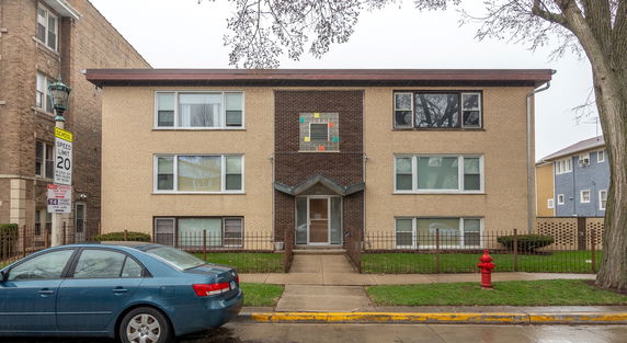 Front view of a two-story apartment building with a brick exterior.