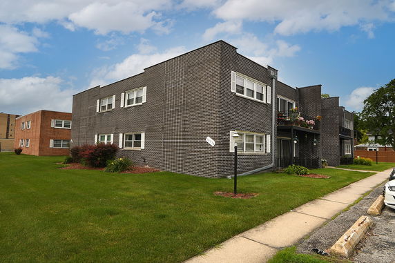 Front view of a two-story brick apartment building.