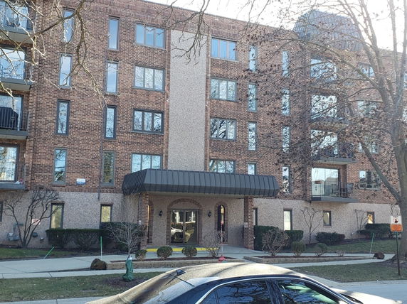 Front view of a multi-story building with brick facade.