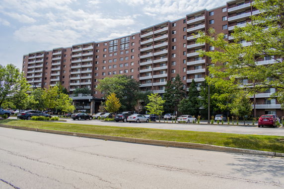 Front view of a multi-story apartment building with balconies.