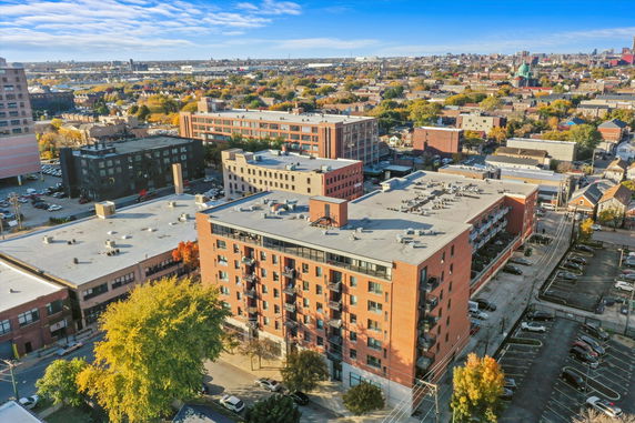 Panoramic view of a cityscape with multiple apartment buildings and surrounding urban area.