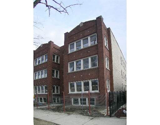 Front view of a multi-story brick apartment building.