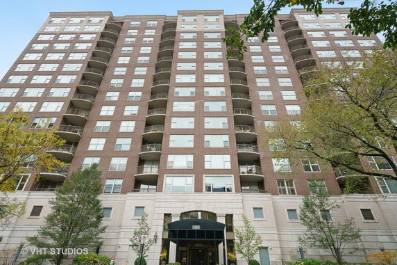 Front view of a multi-story residential building with balconies.