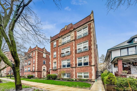 Front view of a multi-story brick apartment building.