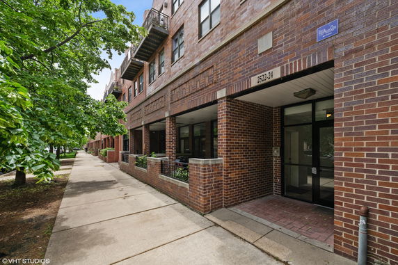 Street view of a multi-story brick building with an entrance.