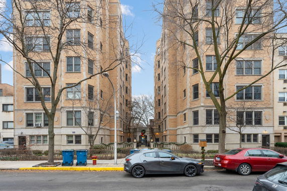 Front view of two multi-story apartment buildings with brick exteriors.