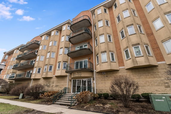 Front view of a multi-story building with balconies.
