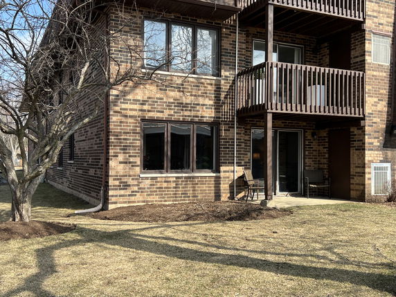 Front view of a two-story brick building with balconies.