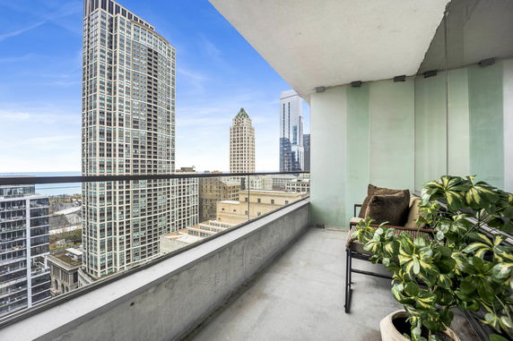 View from a balcony showing high-rise buildings and cityscape.