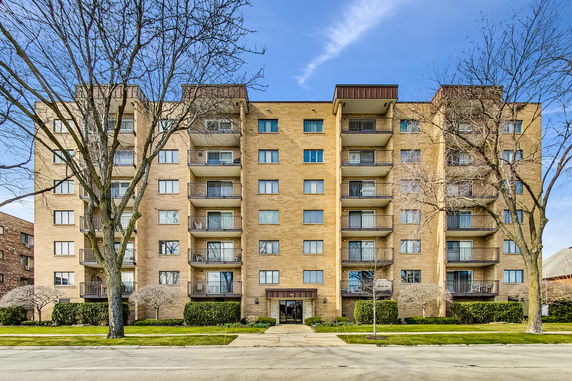 Front view of a multi-story residential building with balconies.