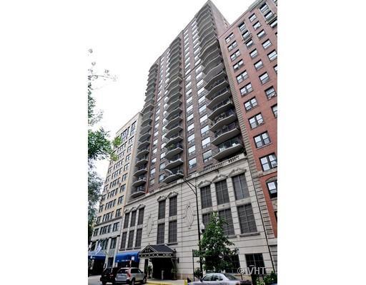 Front view of a tall multi-story residential building with balconies.