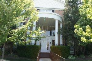 Front view of a building with a round portico and columns.