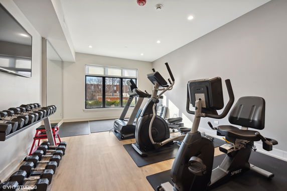 Indoor gym room with exercise equipment including treadmills and a stationary bike.