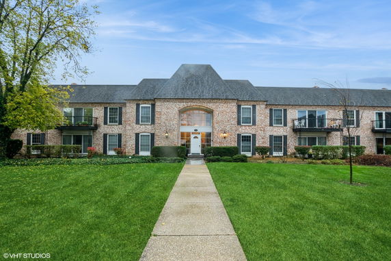 Front view of a two-story brick building with a central entrance.