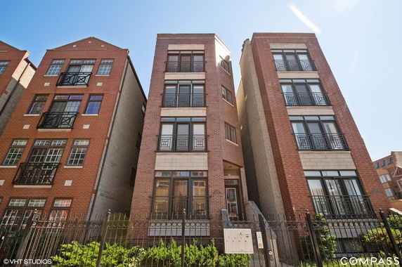 Front view of a multi-story brick residential building.