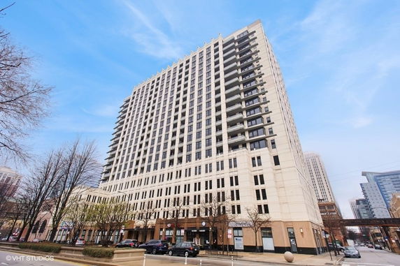 Front view of a tall multi-story building with numerous windows and balconies.