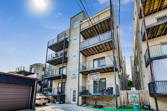View of a multi-story residential building with balconies.