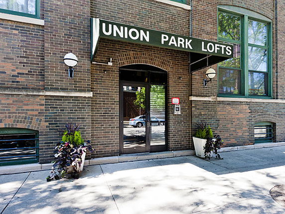 Front entrance of a brick building with 'Union Park Lofts' signage above the door.