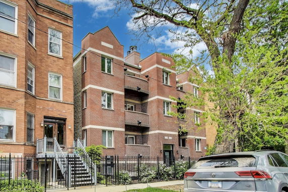 Front view of a three-story brick apartment building.