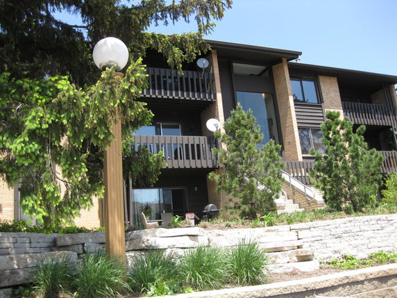 Front view of a multi-story building with balconies.