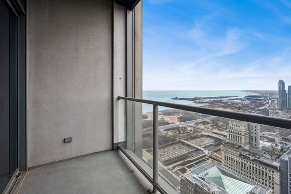 Balcony view overlooking a cityscape and water body.