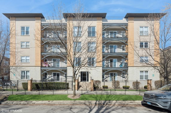 Front view of a multi-story residential building with balconies.