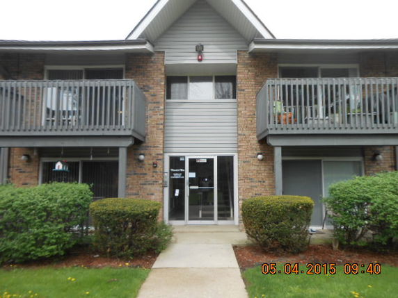 Front view of a two-story building with balconies.