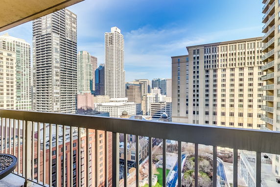 Panoramic view from a balcony showing multiple skyscrapers.
