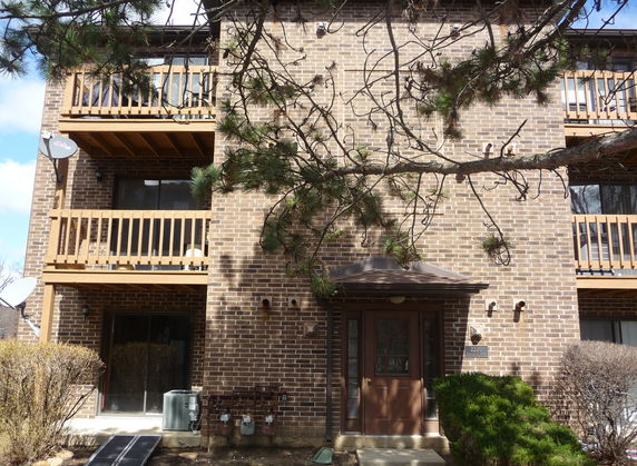 Front view of a multi-story brick building with balconies.