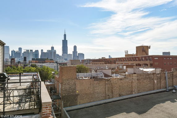 Rooftop view with city skyline in the background.