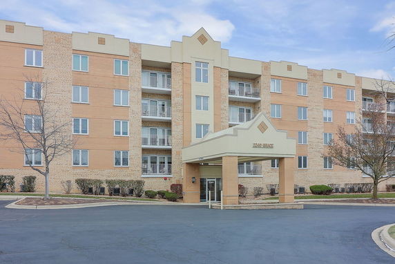 Front view of a multi-story building with an entrance canopy.