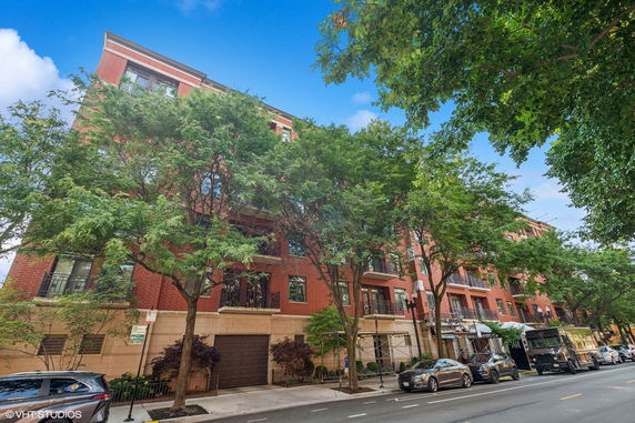 Front view of a multi-story brick building with balconies.