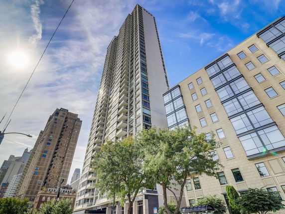 Front view of a tall residential building with multiple floors.