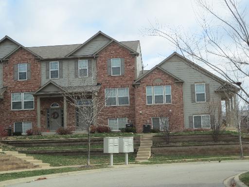 Front view of a two-story house with a brick facade.