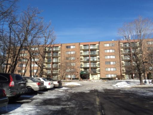 Front view of a multi-story apartment building with balconies