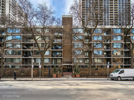 Front view of a multi-story residential building with balconies.