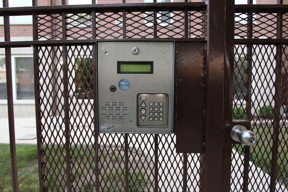 Metal gate with a keypad entry system and intercom.