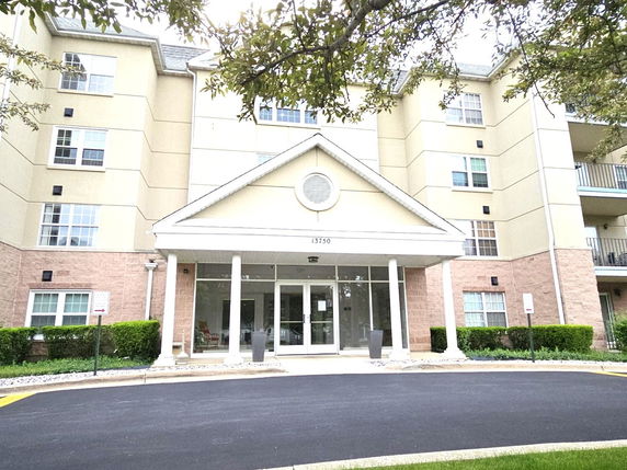 Front view of a multi-story building with a covered entrance.