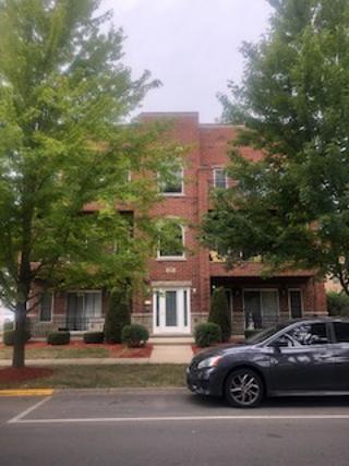 Front view of a multi-story brick building.