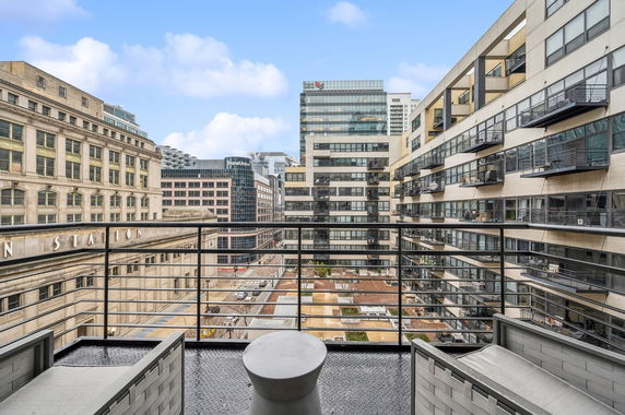 City view from a high-rise balcony showing several modern office buildings.