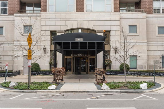 Front view of a multi-story building with an entrance canopy.