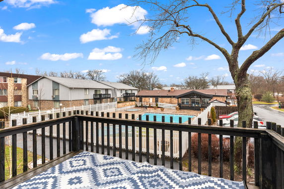 Panoramic view of a residential complex with a swimming pool and multiple buildings.