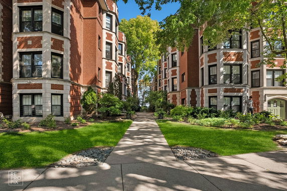 Front view of brick apartment buildings with bay windows.