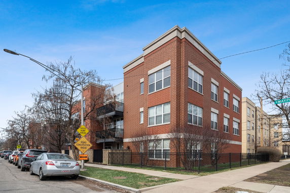 Front view of a multi-story brick residential building.