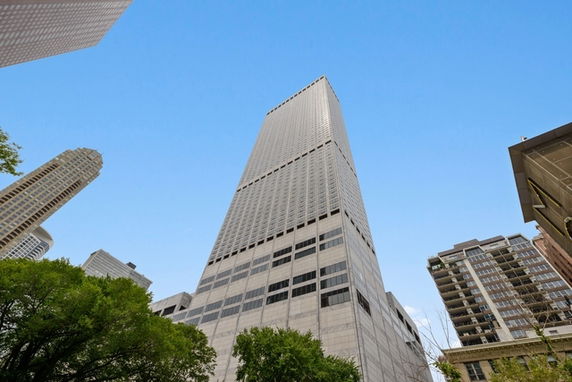 Front view of a tall skyscraper with a modern facade.