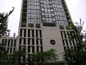 Front view of a multi-story building with large windows.