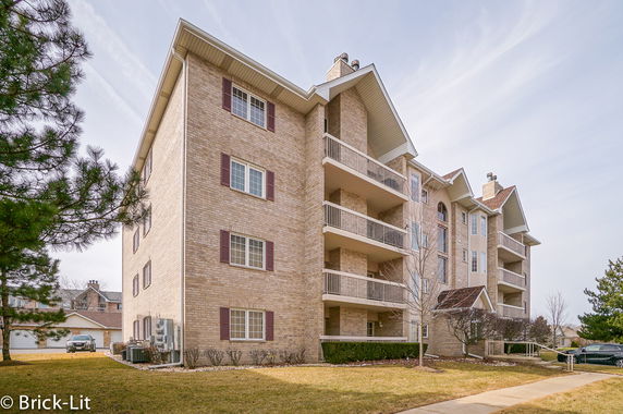Front view of a multi-story residential building with balconies.